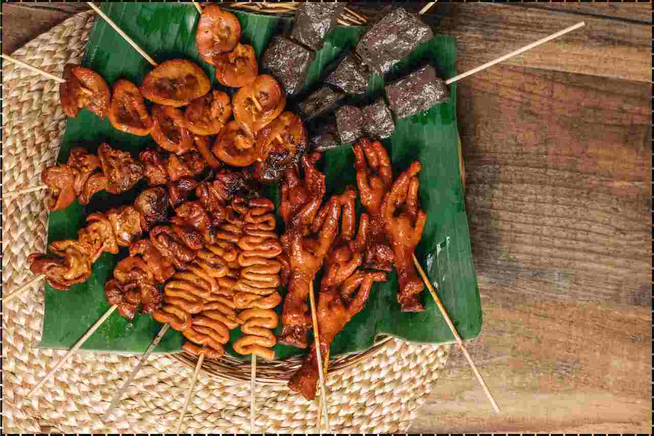 Delicious Filipino street fare food with chiken presented on eco-friendly banana leaves